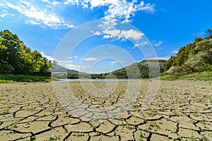 Lake eleshnitsa with cracked mud pattern in foreground
