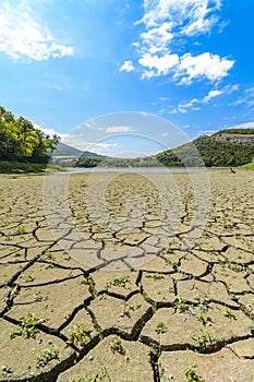 Lake eleshnitsa with cracked mud pattern in foreground