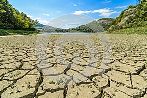 Lake eleshnitsa with cracked mud pattern in foreground