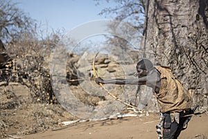 Hadzabe man shooting his wooden arrows