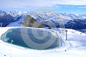 Lake for feeding the snow machines in the swiss alps at Parsenn