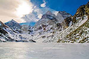 Lake Fiorenza covered with ice on the slopes of Monviso