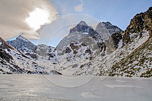 Lake Fiorenza covered with ice on the slopes of Monviso