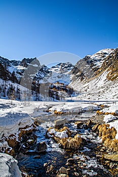 Lake Fiorenza covered with ice on the slopes of Monviso