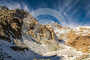 Lake Fiorenza covered with ice on the slopes of Monviso photo