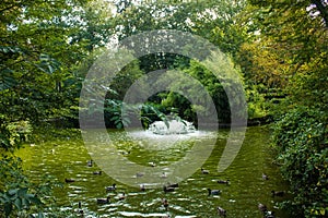 Lake and fontain inside the natural urban park at the Allier lakeshore in Vichy, France