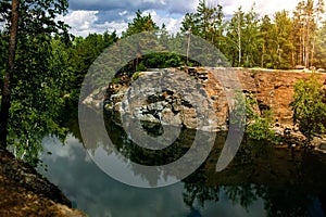 Lake In The Forest With Stone Precipices. Stone Quarry In The Forest.