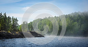 Lake, forests and haze over the water