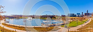 The lake, Fountain, fall vegetation, trails and surrounding downtown Omaha Nebraska buildings at the Heartland of America Park