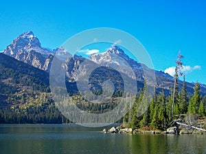 a lake in front of the rocky mountains