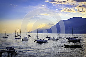 Lake Garda Harbour at sunset with boats photo