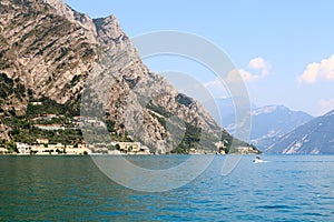 Lake Garda and mountain panorama with boat in Limone