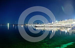 Lake Geneva at night. View of the ship and boats in the harbor