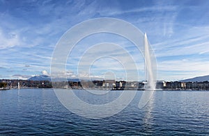 Lake Geneva Switzerland with water fountain and blue sky with cl