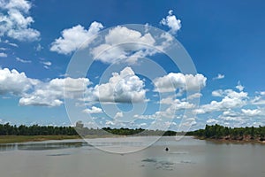 Lake and green forest with blue sky white cloud