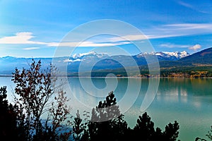 Lake with green water, mountains and sky