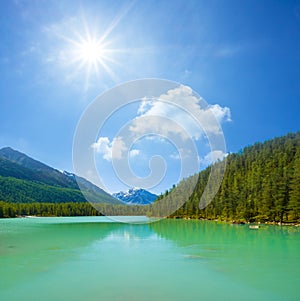 lake in gren mountain valley under a sparkle sun