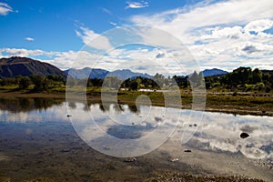 Lake Hayes is located between Queenstown and Arrowtown