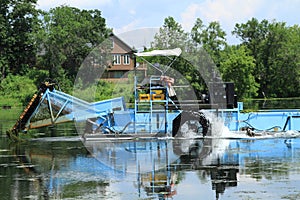 Lake home with vegetation harvester