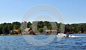 Lake House on the Lake with a Pontoon Boat in the Water