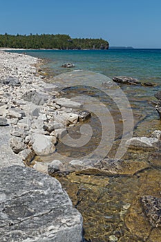 Lake Huron shoreline blue green water and limestone rocks along