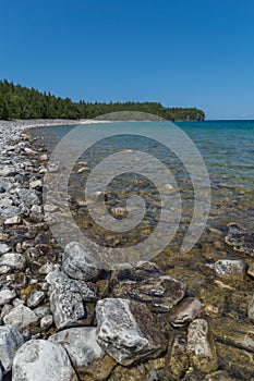 Lake Huron shoreline blue green water and limestone rocks along