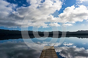 Lake Ianthe with wooden jetty on calm sunny day