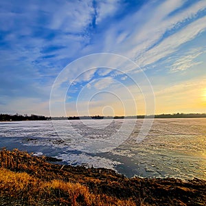 Lake with Ice and Interesting Clouds during Sunset