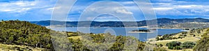 Lake Jindabyne landscape with overcast sky and rural foreground