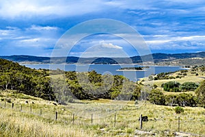Lake Jindabyne landscape with overcast sky and rural foreground