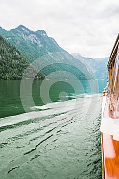 Lake Kenigssee. A personal look along the boat from the bow to the stern with a view of the lake and mountains, the