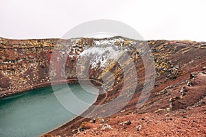 Lake Kerid is a crater lake or volcanic lake, in the crater of a volcano in Iceland. Unusual red soil, similar to the
