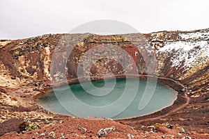 Lake Kerid is a crater lake or volcanic lake, in the crater of a volcano in Iceland. Unusual red soil, similar to the