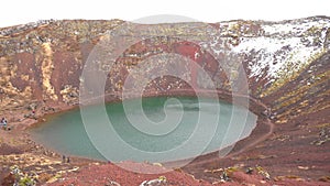 Lake Kerid is a crater lake or volcanic lake, in the crater of a volcano in Iceland. Unusual red soil, similar to the