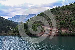 Lake Komani, Albania - May 18, 2017: Onboard morning Lake Komani ferry from Fierza to Koman in Albania - picking up people at a 