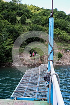 Lake Komani, Albania - May 18, 2017: Onboard morning Lake Komani ferry from Fierza to Koman in Albania - picking up people at a 