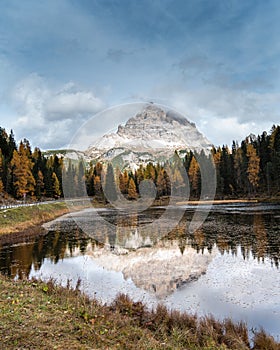The lake of Lago di antorno with Tre cime di lavadero mountain reflection in autumn. Forest landscape Italy