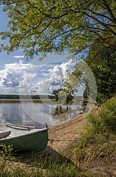 Lake landscape in Finland, boat and beach