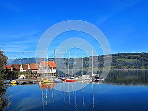 Lake with modern stilt houses and sailing boats