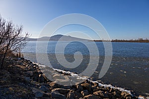 The lake landscape of Musov Czech Republic. View of Lake Musovske and Palava in the Czech Republic. Ice floes in the foreground.