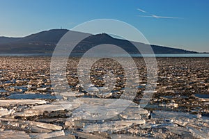 The lake landscape of Musov Czech Republic. View of Lake Musovske and Palava in the Czech Republic. Ice floes in the foreground.