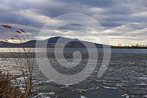 The lake landscape of Musov Czech Republic. View of Lake Musovske and Palava in the Czech Republic. Ice floes in the foreground.