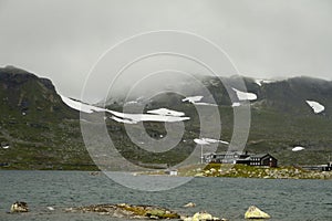 Lake landscape with snowcapped mounutains in background