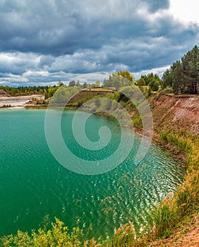 lake in the limestone quarry on a cloudy gloomy summer day