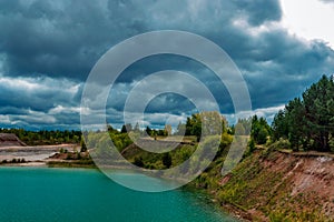 lake in the limestone quarry on a cloudy gloomy summer day