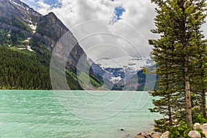 Lake Louise, Banff National Park, Alberta, Canada. Backpack hiker looks on amazing landscape. Active life.