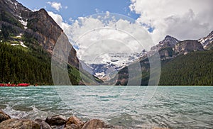 Lake Louise in Banff National Park, Alberta, Canada. Lake Louise panorama of snow-capped mountain peaks, coniferous forest