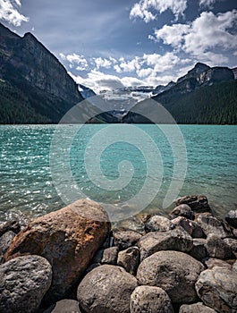 Lake Louise landscape of rocky forefront and rocky mounatin backdrop.