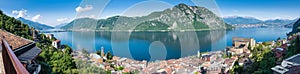 Lake Lugano. Panoramic view of Campione d`Italia, famous for its casino. In the background on the right the city of Lugano