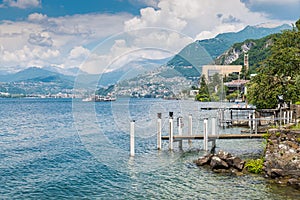 Lake Lugano. View of Campione d`Italia, famous for its casino visible on the right, with a tourist boat arriving